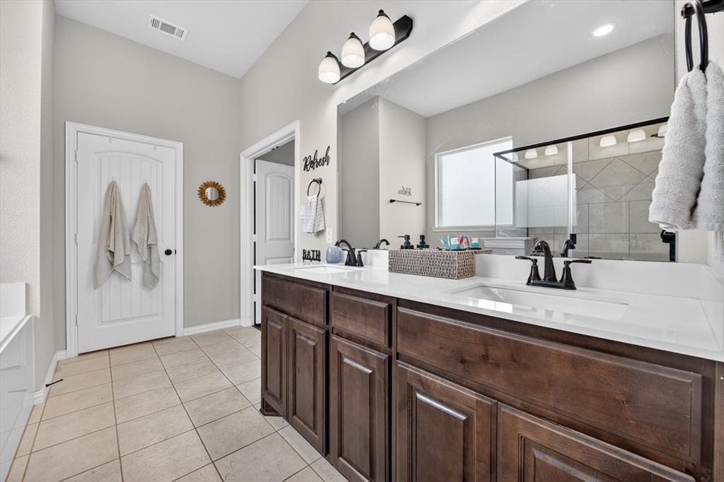 150 Chester Road Springtown, TX 76082 - Photo 33 of 40 a spacious bathroom with a sink a mirror and a shower