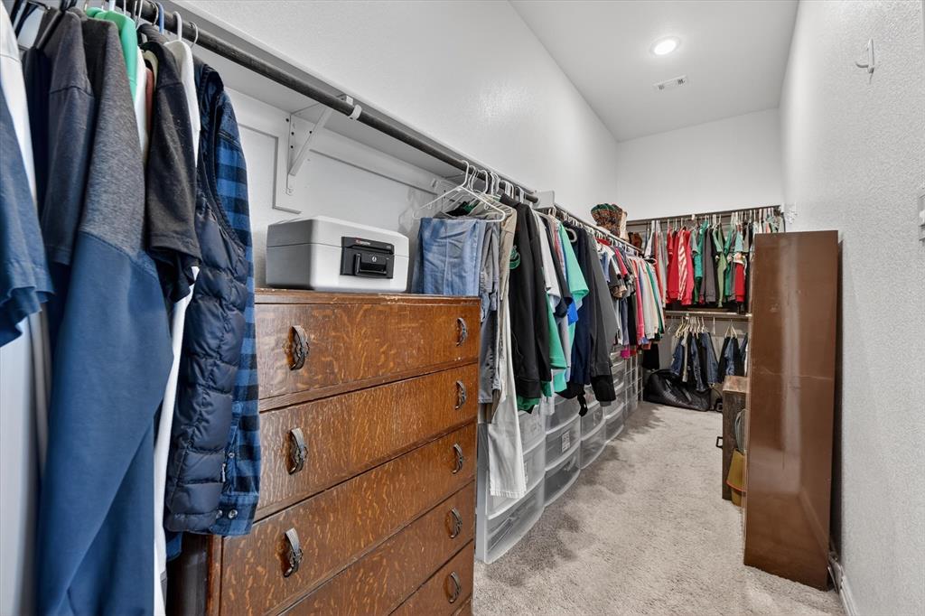 150 Chester Road Springtown, TX 76082 - Photo 34 of 40 a view of walk in closet with clothes and shoes