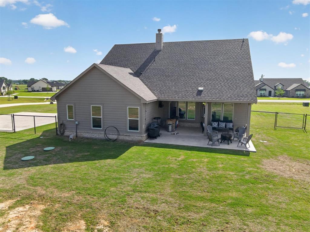 150 Chester Road Springtown, TX 76082 - Photo 37 of 40 a view of a house with a swimming pool and a yard