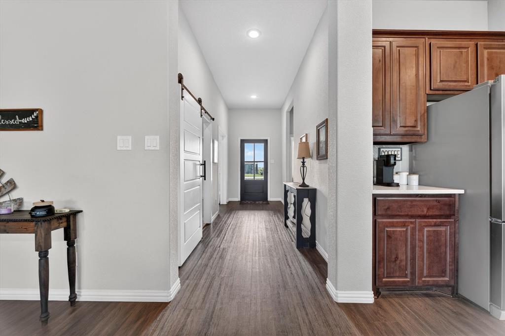 150 Chester Road Springtown, TX 76082 - Photo 5 of 40 a view of hallway with wooden floor and stairs