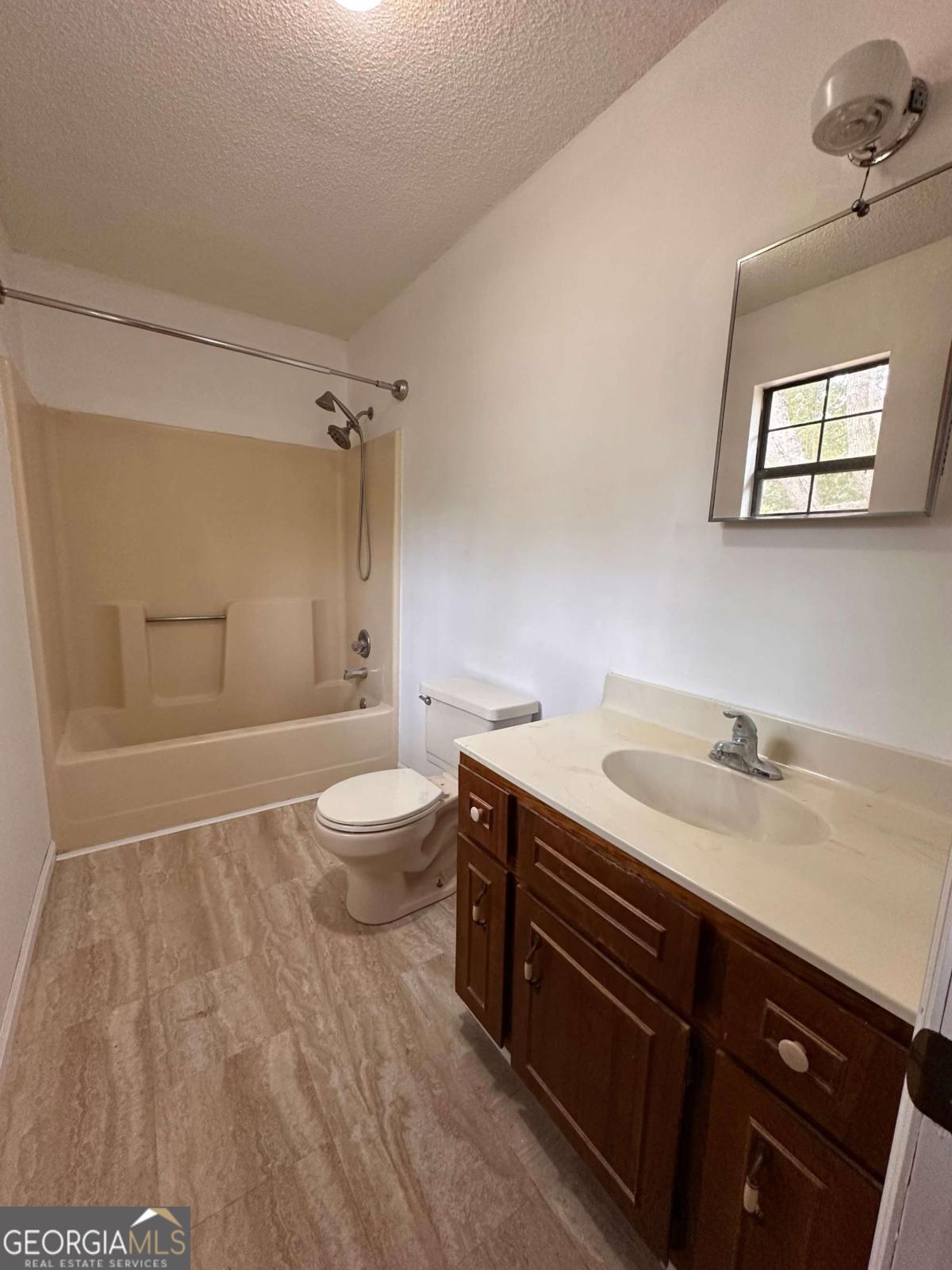 562 Mush Bluff Road St. Marys, GA 31558 - Photo 11 of 22 a bathroom with a granite countertop sink toilet a mirror and shower