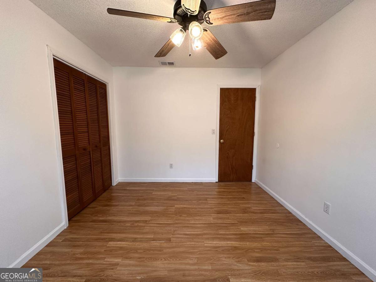 562 Mush Bluff Road St. Marys, GA 31558 - Photo 17 of 22 a view of an empty room and chandelier fan