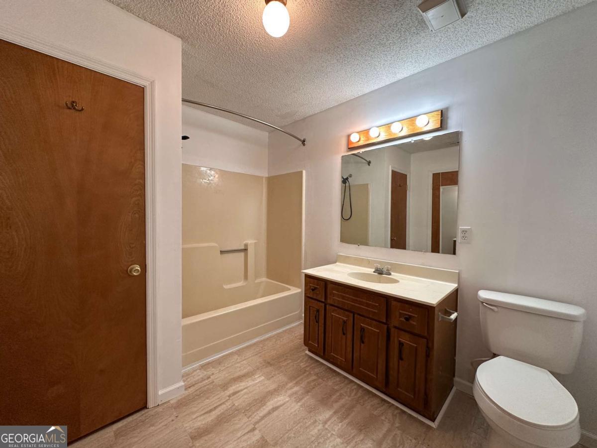 562 Mush Bluff Road St. Marys, GA 31558 - Photo 19 of 22 a bathroom with a toilet a sink and mirror