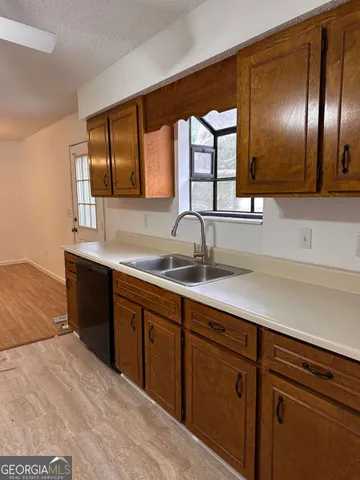 a spacious bathroom with double vanity and a large mirror