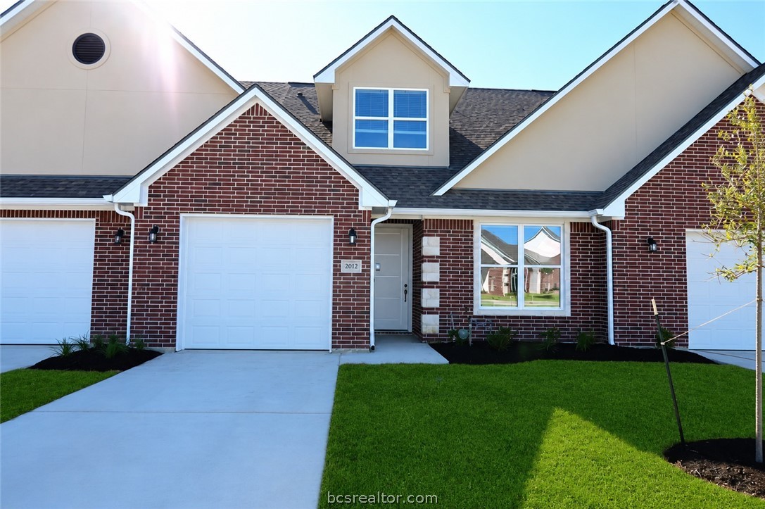 2012 Reagan Court Bryan, TX 77802 - Photo 2 of 19 a front view of a house with a garden and yard