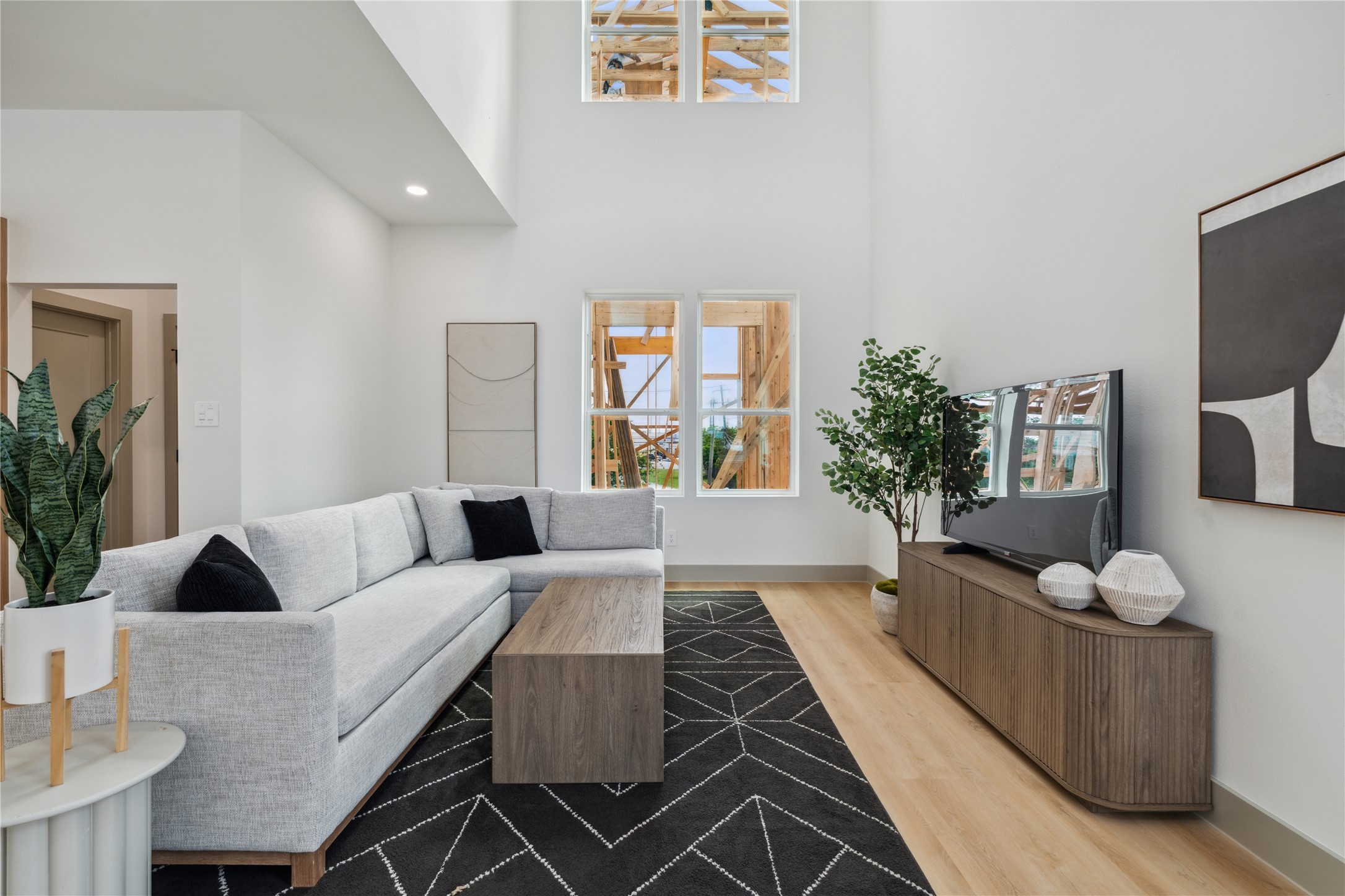 2943 Delafield Street Houston, TX 77023 - Photo 13 of 41 Thoughtfully scaled furnishings and wood tones soften the vertical drama of this modern living room retreat.