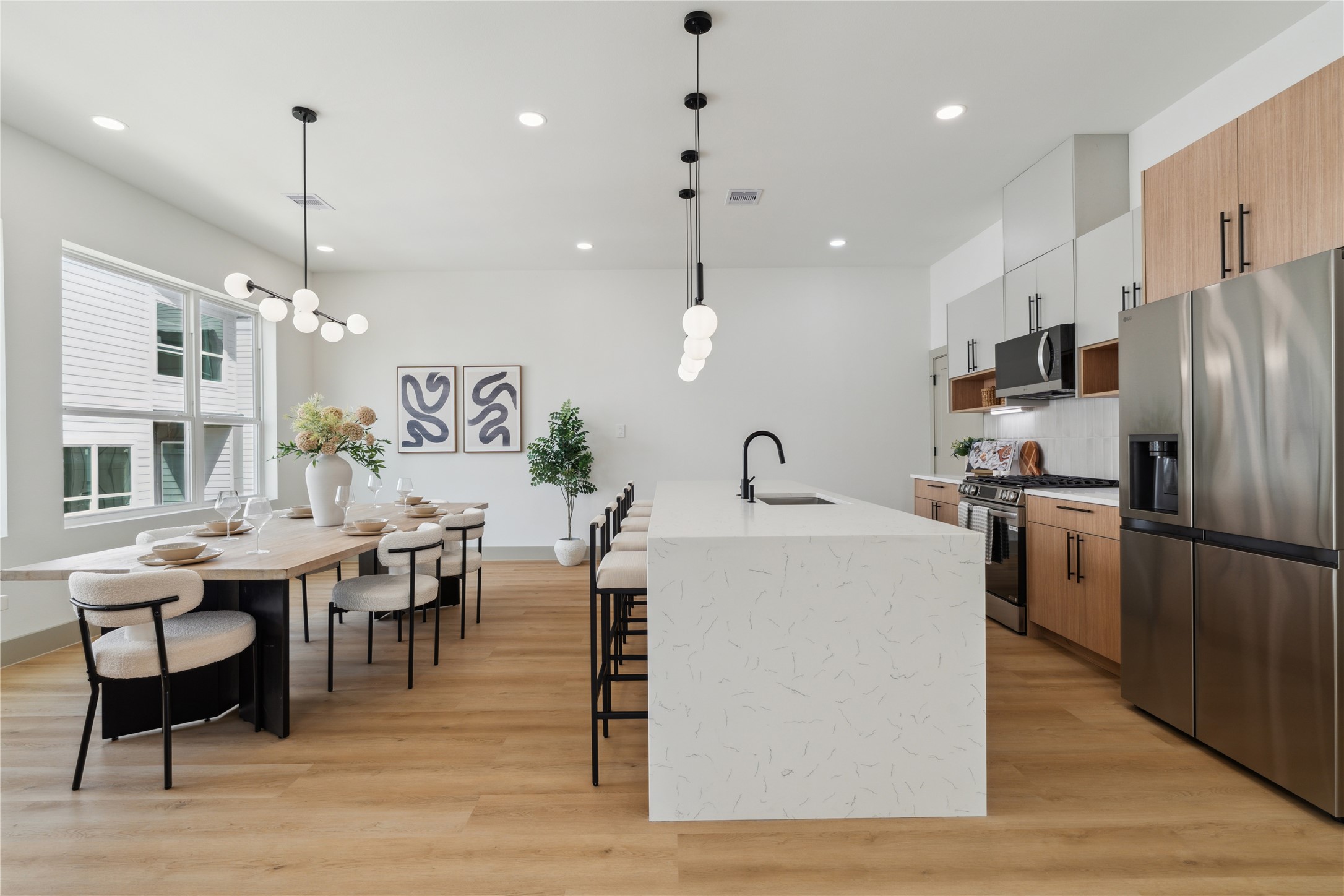 2943 Delafield Street Houston, TX 77023 - Photo 15 of 41 Clean lines, vertical cabinetry, and mixed wood tones evoke a Scandinavian-inspired sophistication, blending style with function.
