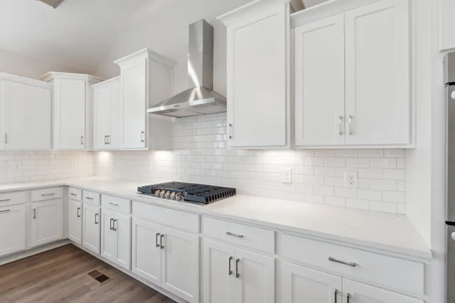 a view of a small space with wooden floor and a window