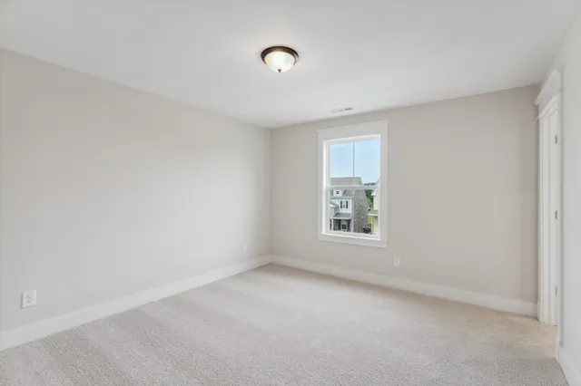 an empty room with closet area and mirrors