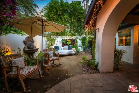 an outdoor space with furniture and umbrella