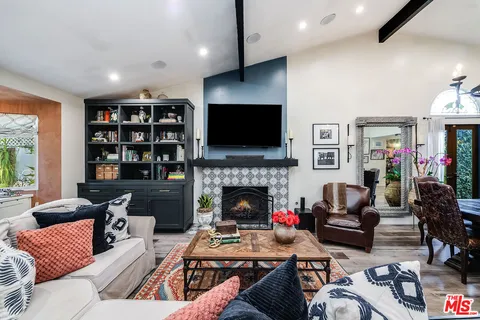 a view of a dining room with furniture a chandelier and wooden floor