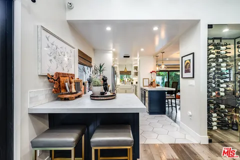 a kitchen with a stove a sink and cabinets