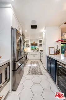 a kitchen with stainless steel appliances granite countertop a refrigerator and a stove top oven