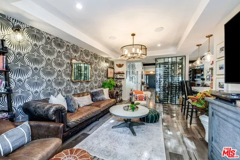 a bedroom with furniture and a flat screen tv