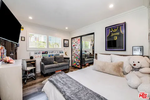 a bedroom with a bed and flat screen tv