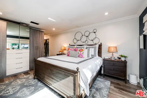 a spacious bathroom with a double vanity sink a mirror and a bathtub
