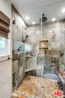 a view of a patio with a dining table and chairs under an umbrella