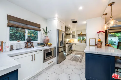 a kitchen with a sink stainless steel appliances and cabinets