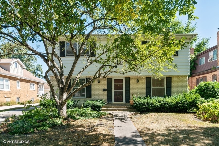 635 Spring Road Elmhurst, IL 60126 - Photo 1 of 16 a front view of a house with a garden