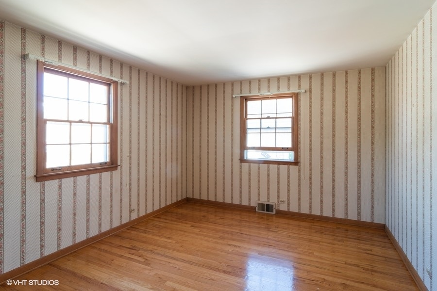 635 Spring Road Elmhurst, IL 60126 - Photo 11 of 16 an empty room with wooden floor and windows