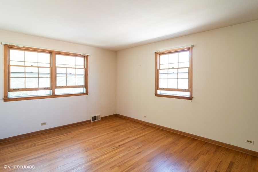 635 Spring Road Elmhurst, IL 60126 - Photo 12 of 16 an empty room with wooden floor and windows