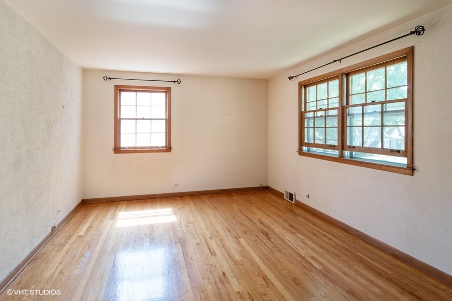 635 Spring Road Elmhurst, IL 60126 - Photo 13 of 16 a view of an empty room with wooden floor and a window