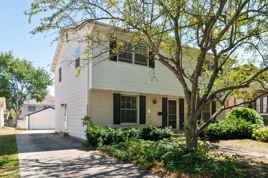 635 Spring Road Elmhurst, IL 60126 - Photo 16 of 16 a view of a house with a yard and potted plants