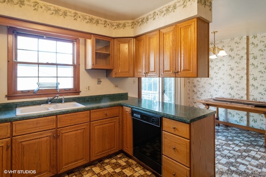 635 Spring Road Elmhurst, IL 60126 - Photo 5 of 16 a kitchen with granite countertop wooden cabinets a sink and a window
