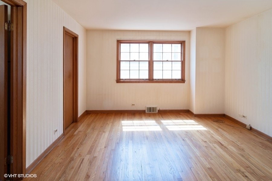 635 Spring Road Elmhurst, IL 60126 - Photo 9 of 16 an empty room with wooden floor and windows
