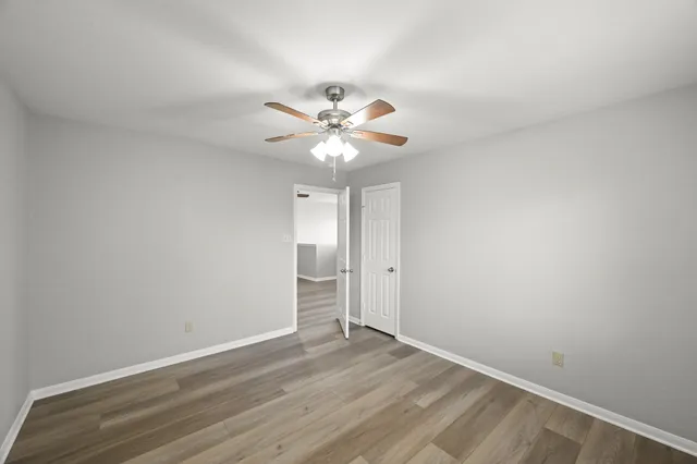 a view of an empty room with wooden floor