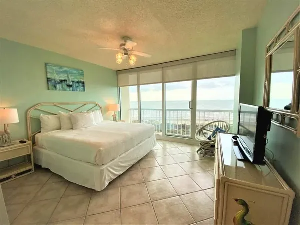 a bedroom with a bed and glass walk in closet