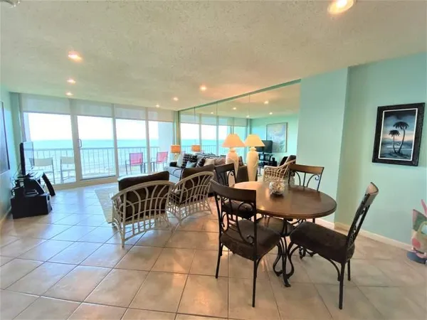 a room with lots of chairs and view of living room
