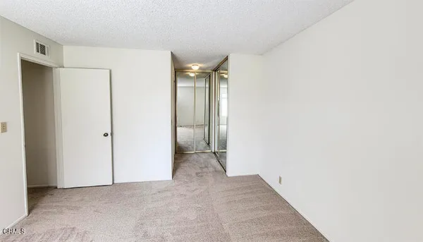 a view of entrance gate of the house and car parked