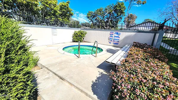 a view of a swimming pool with a patio and a yard