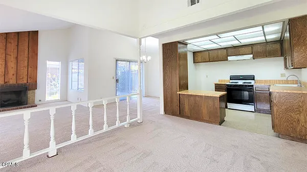 a view of empty room with wooden floor and windows