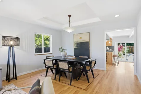 a view of a dining room with furniture and a chandelier