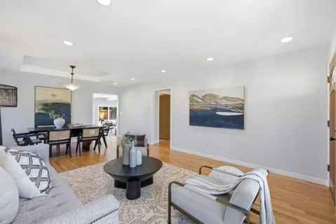 a living room with furniture and wooden floor