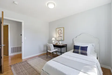 a bedroom with furniture and a window