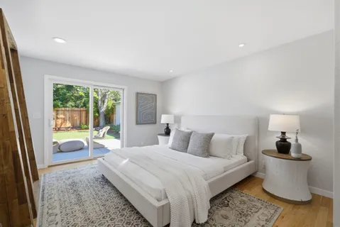 a bedroom with a large bed and a chandelier