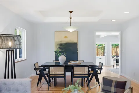 a dining room with furniture and window
