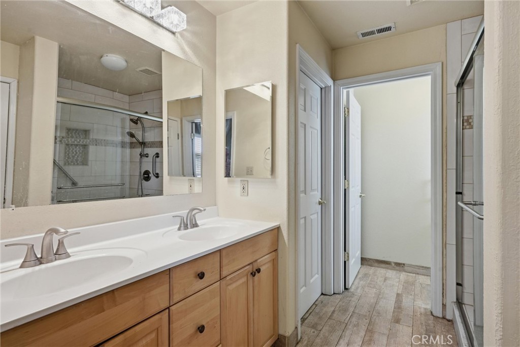 18846 Horseshoe Road Hidden Valley Lake, CA 95467 - Photo 15 of 31 a bathroom with a double vanity sink and mirror
