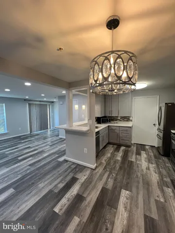 a kitchen with stainless steel appliances granite countertop a stove and cabinets