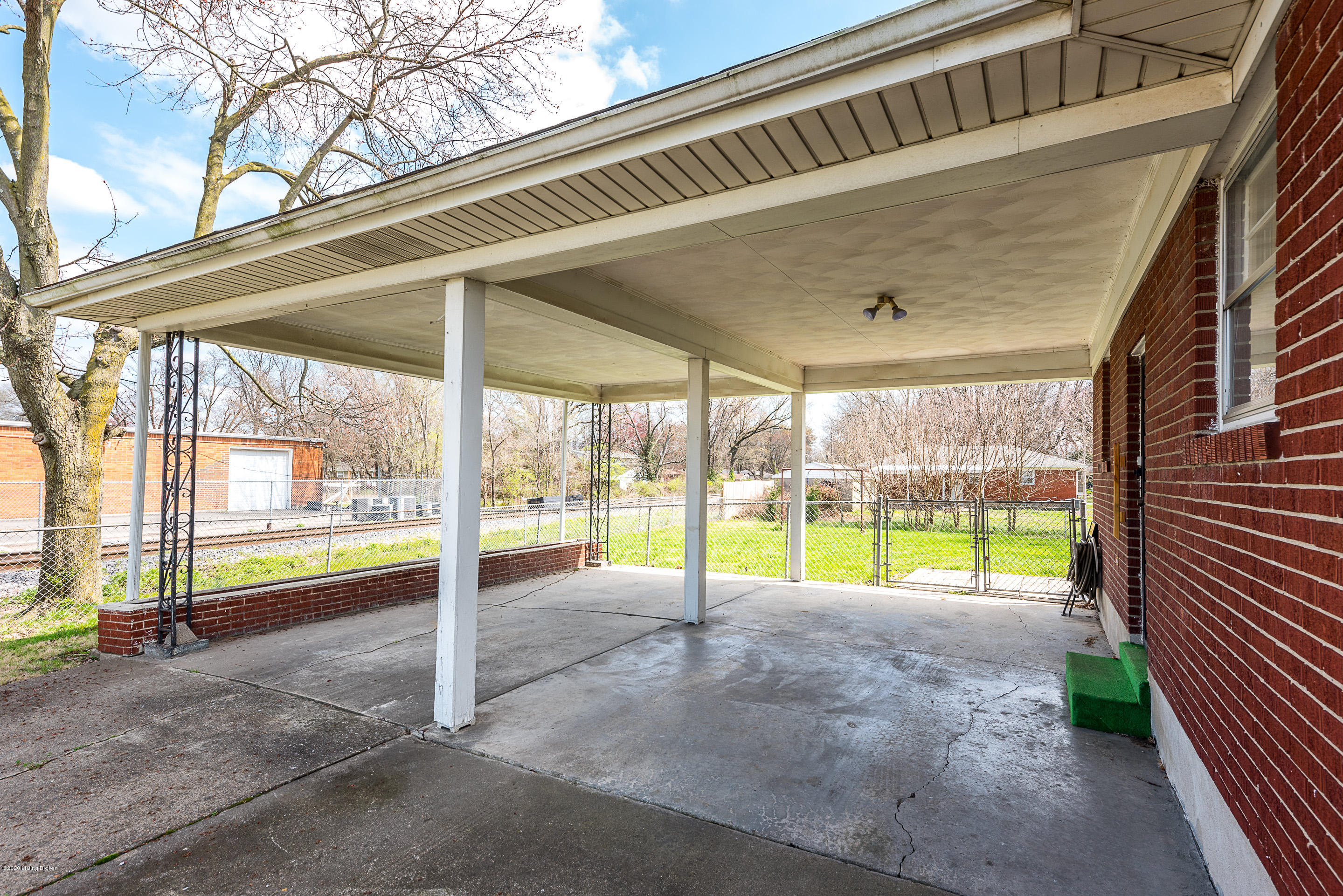 3901 Cane Run Road Louisville, KY 40216 - Photo 33 of 34 THE CARPORT OFFERS COVERED PARKING FOR 2 CARS WITH EASY ACCESS TO THE SIDE ENTRY DOOR INTO THE KITCHEN.
