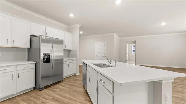 a kitchen with stainless steel appliances a refrigerator sink and cabinets