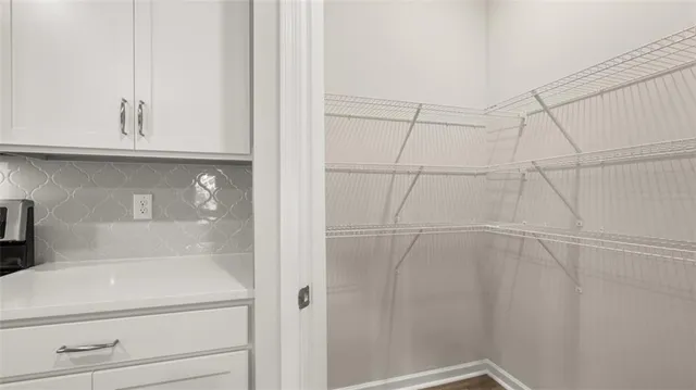 a view of a room with a large trees and plants