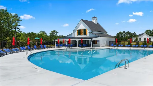 a view of a swimming pool with a fountain and a yard