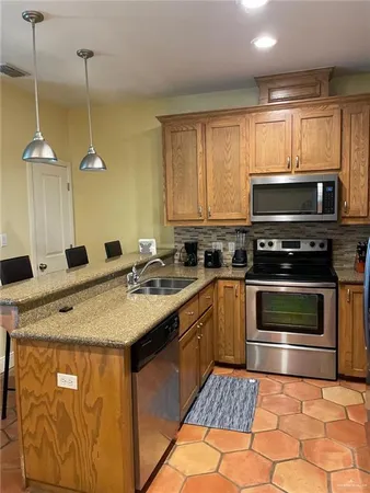 a kitchen with a sink stove and microwave