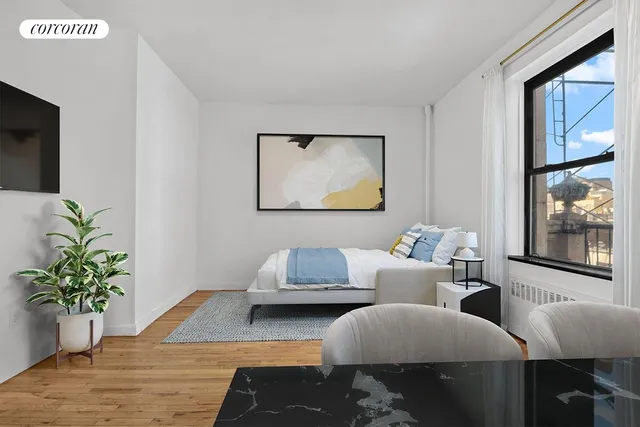 a living room with furniture potted plant and a window