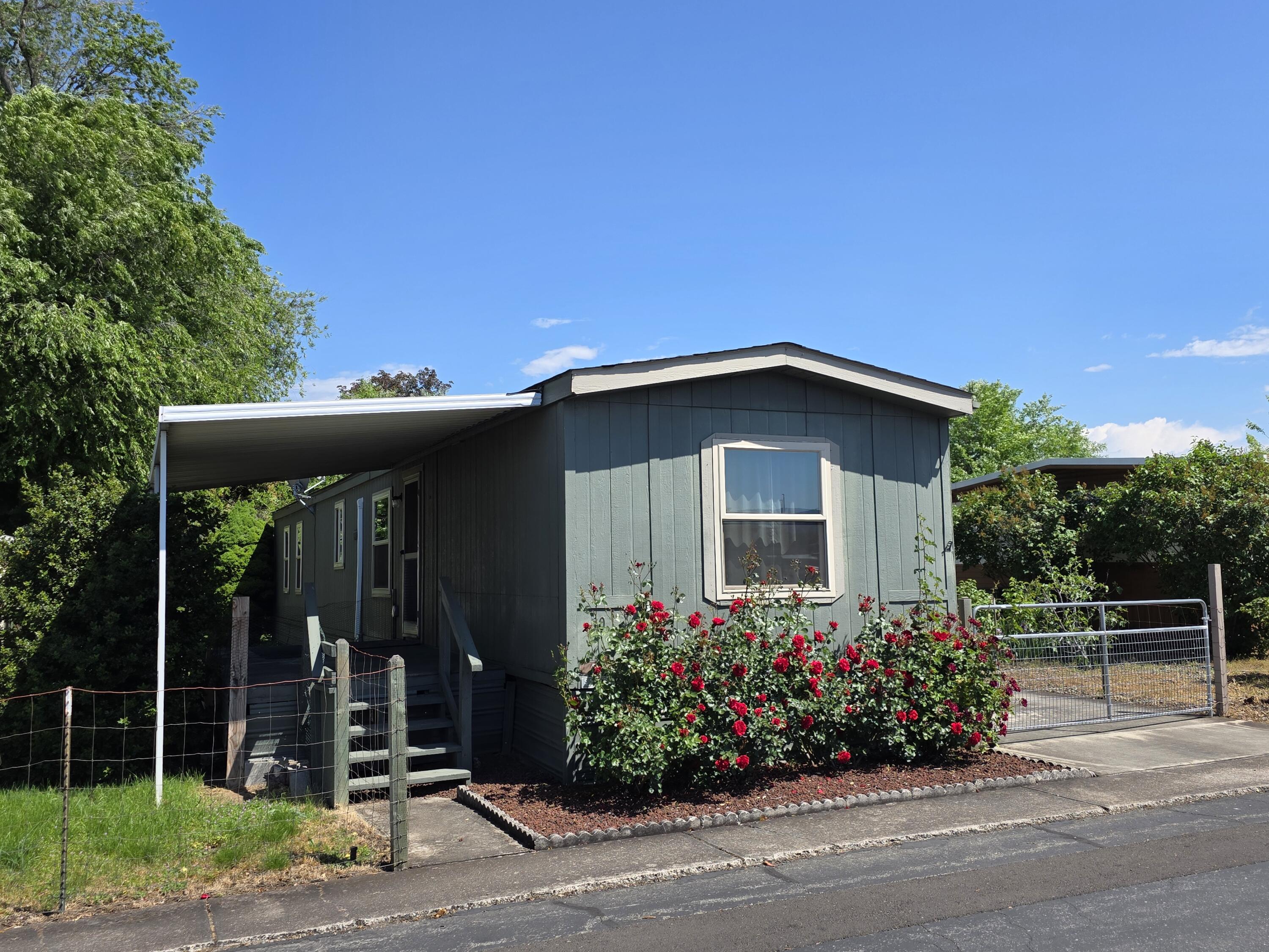 301 Freeman Road, Unit 30 Central Point, OR 97502 - Photo 1 of 26 a front view of a house with a garden