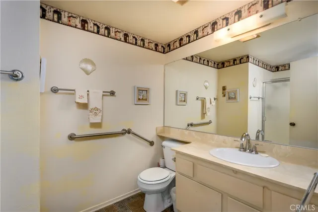 a bathroom with a sink mirror vanity and toilet